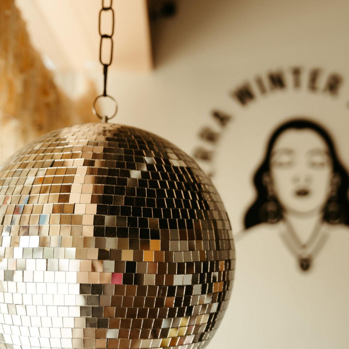  disco ball with a blurred background featuring a jewelry brand logo