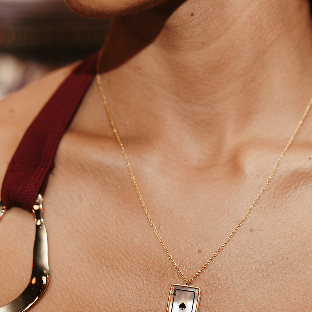 gold and mother of pearl playing card inspired token necklace sierra winter