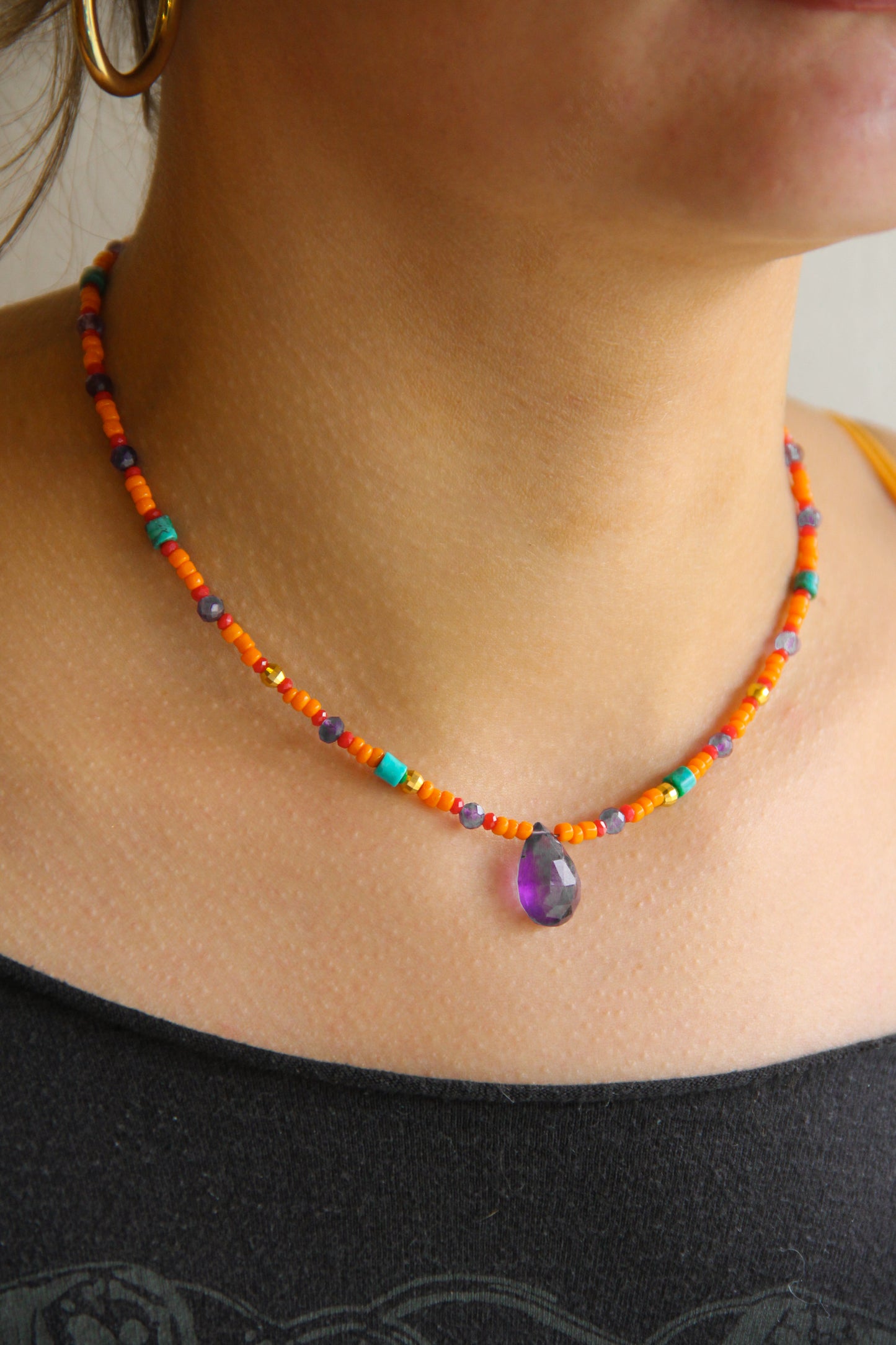 orange and purple beaded necklace with large amethyst drop stone