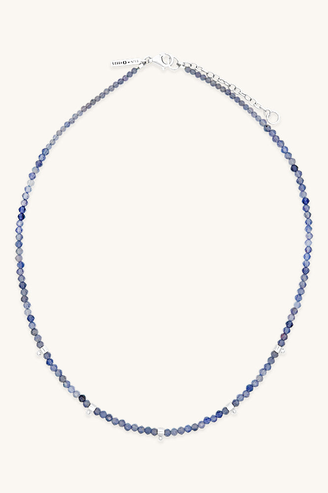 Blue beaded necklace on a white background