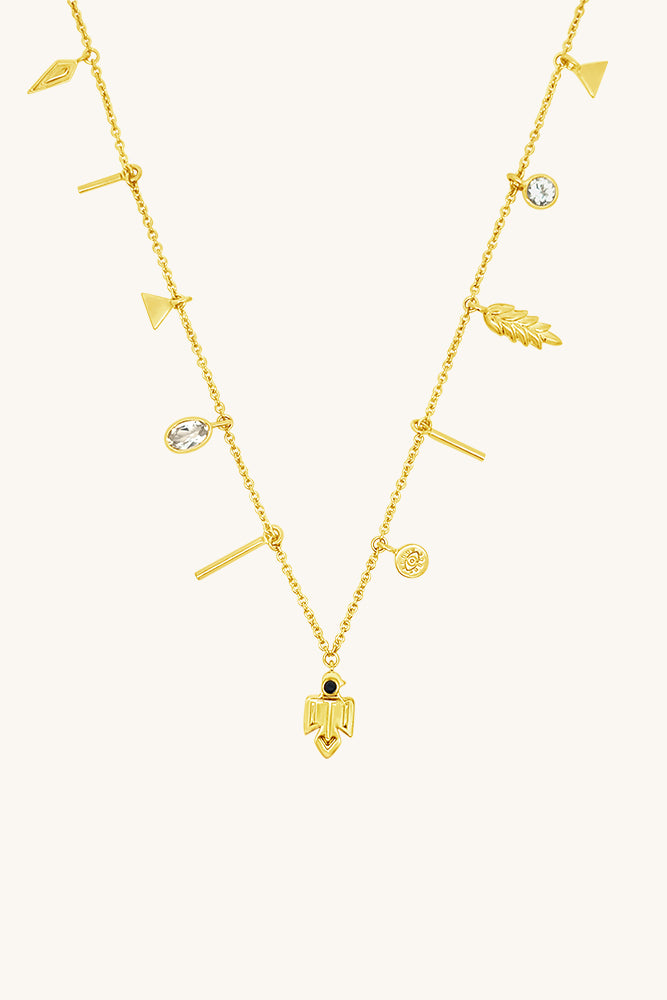 Gold necklace with various pendants, wheat, thunderbird, evil eye, white topaz stones, talisman