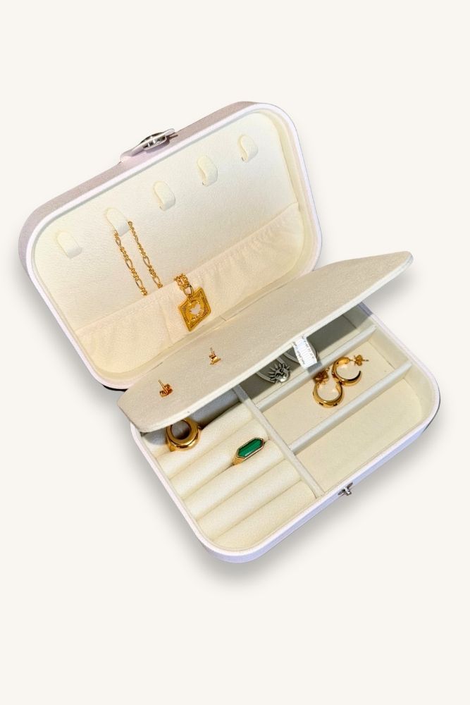 White jewelry box with gold text on a white background