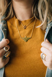 gold and black diamond thunderbird necklace
